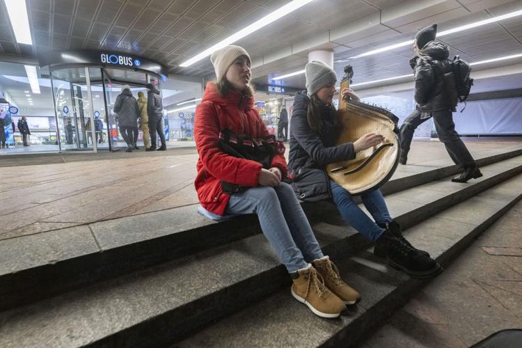Olga Verbeshchuk plays the Ukrainian folk instrument Bandura while her twin sister Svitlana sings in the tunnels below Kyiv, Ukraine, Friday, Dec. 15, 2023. The two are music students at the The Dragomanov Ukrainian State University in Kyiv. (The Gazette, Christian Murdock)